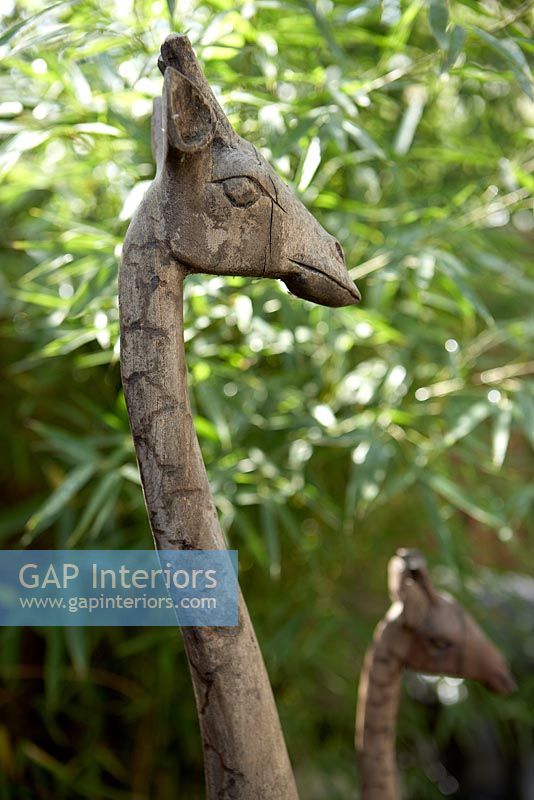 Carved wooden giraffe in garden, detail