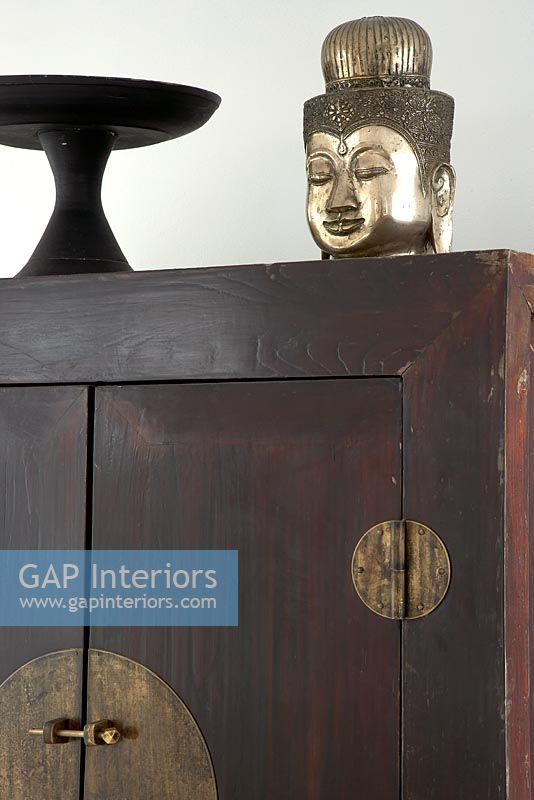 Large wooden oriental cupboard and sculpture
