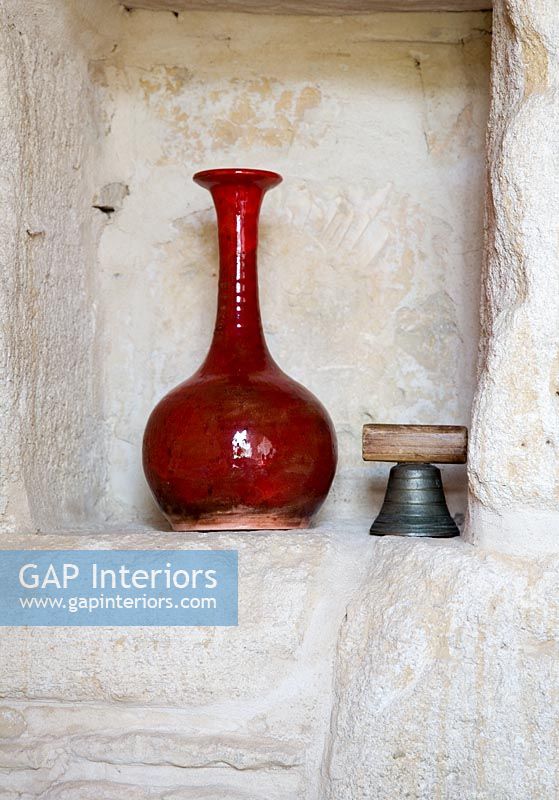 Vase and bell in alcove