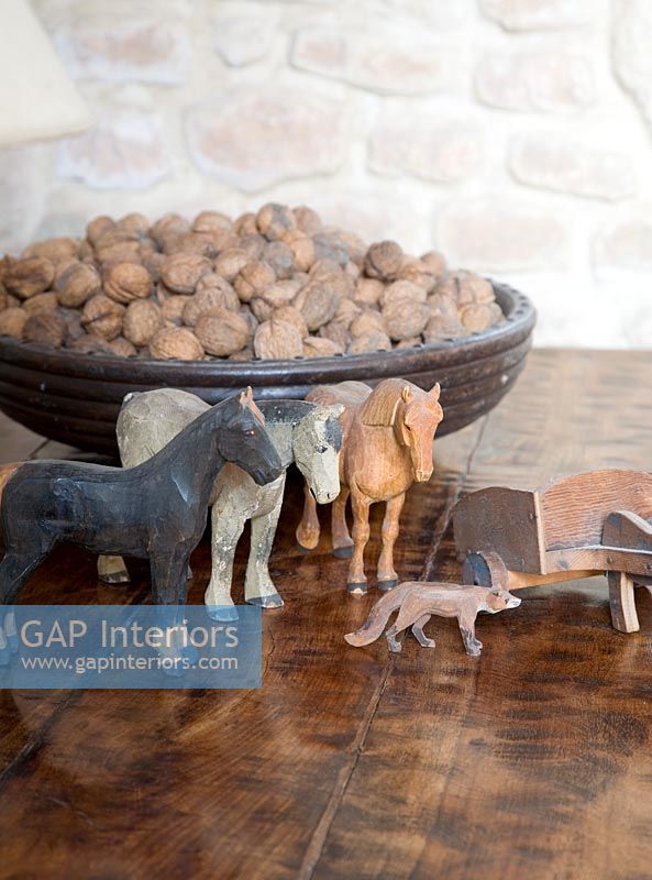 Wooden animal toys and bowl of nuts