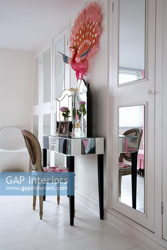White bedroom with mirrored dressing table