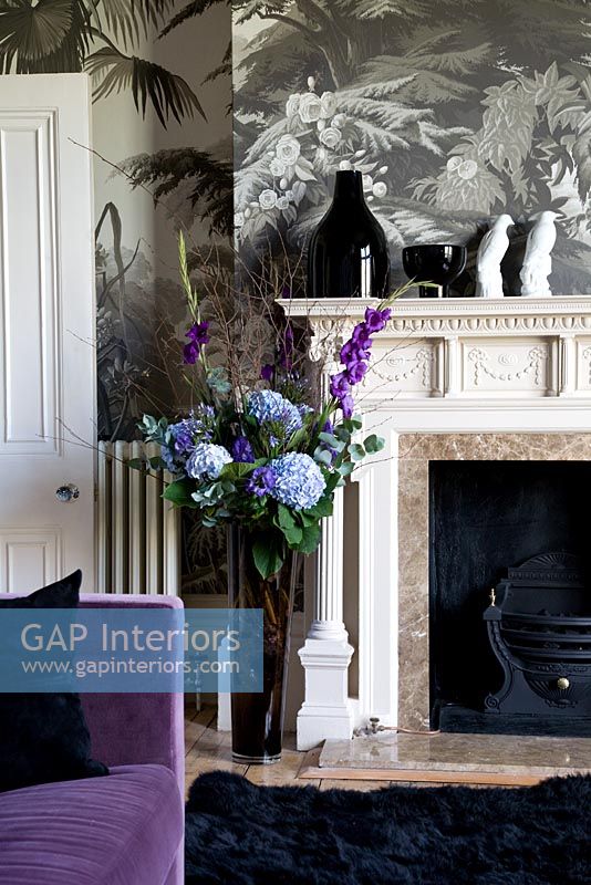 Flowers by fireplace