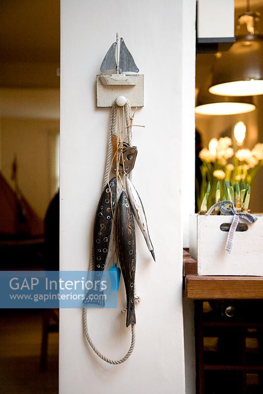 Toy fish hanging from novelty wooden hook