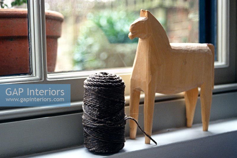 Twine and horse ornament on windowsill