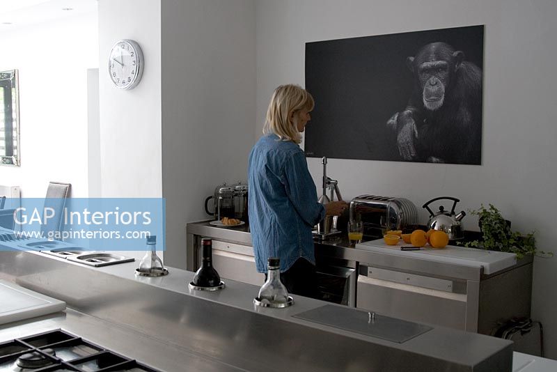 Woman using toaster in contemporary kitchen