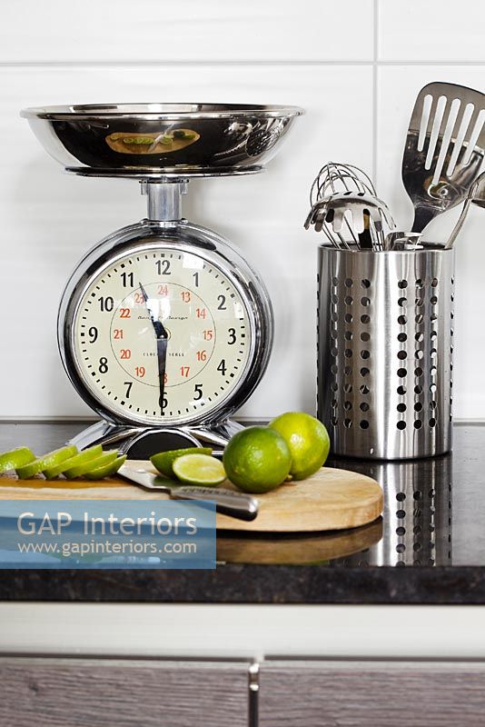 Scales and utensils on modern kitchen worktop
