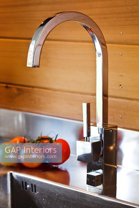 Kitchen tap and wooden panelling