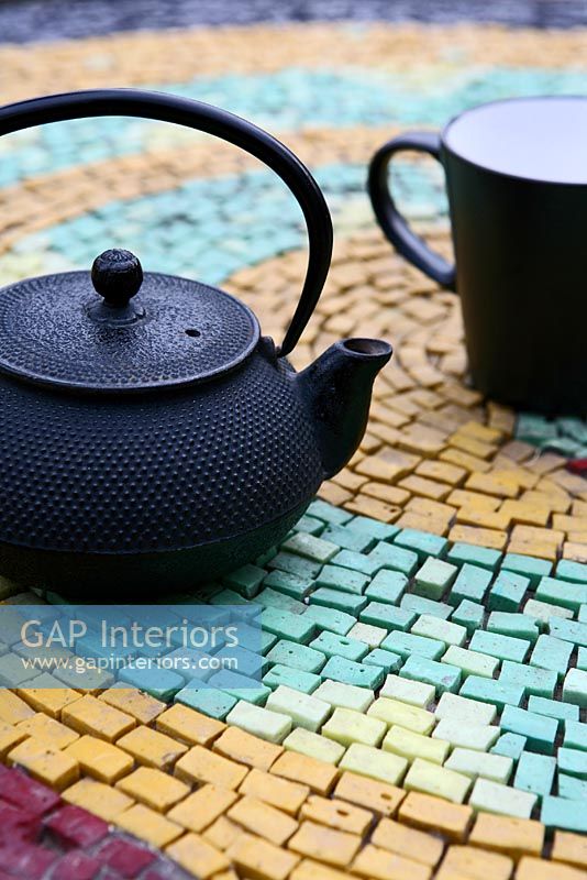 Black teapot and cup on table