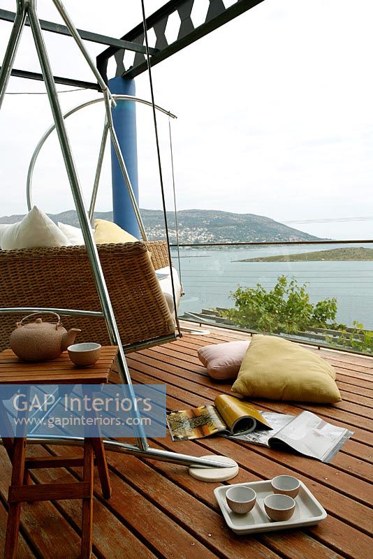 Contemporary swing seat on deck with sea view