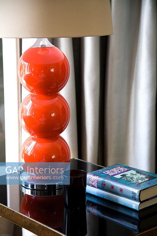 Red glass lamp on side table