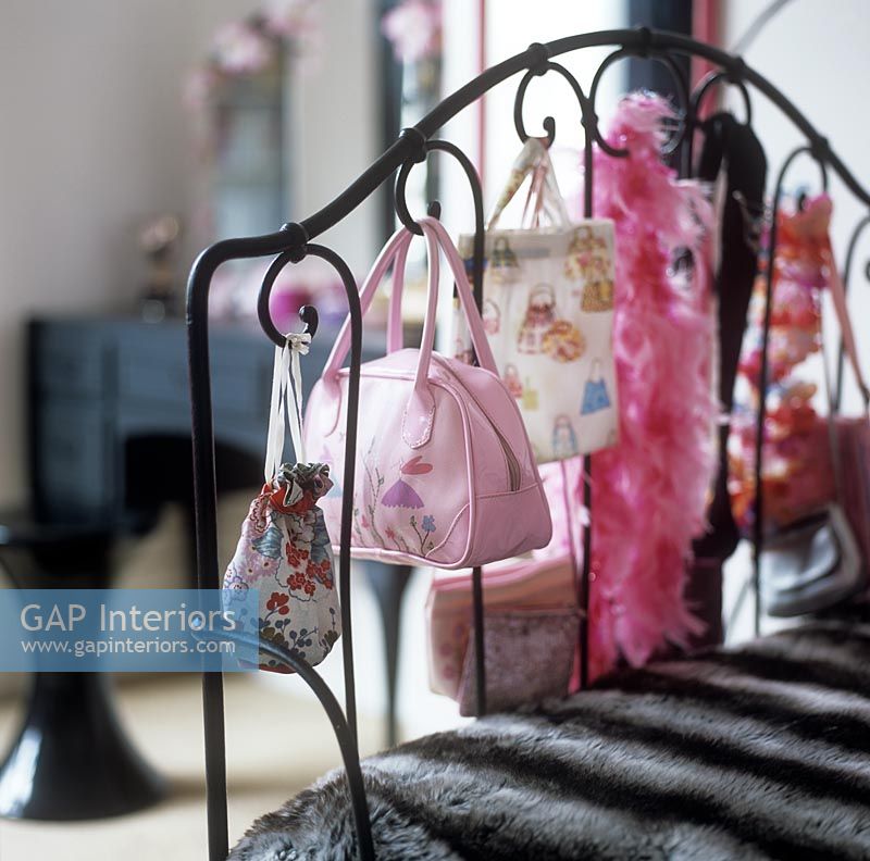 Bags and accessories on iron bedstead 