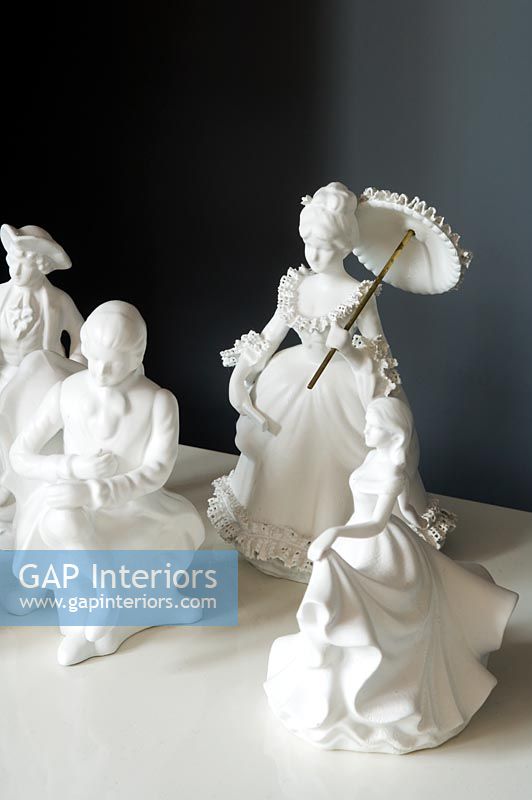 Display of white porcelain figures 