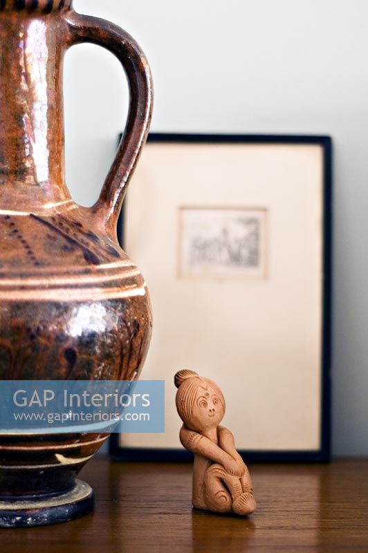 Terracotta figure and earthenware jug