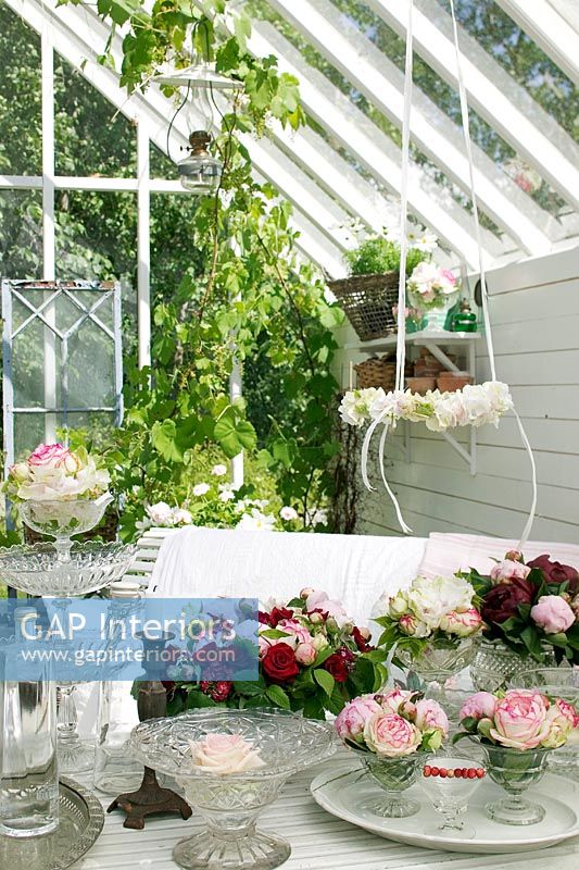 Conservatory with flower arrangements on table