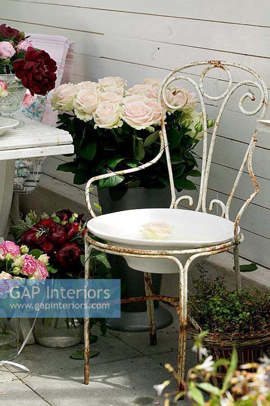 Vintage iron chair and flower arrangements