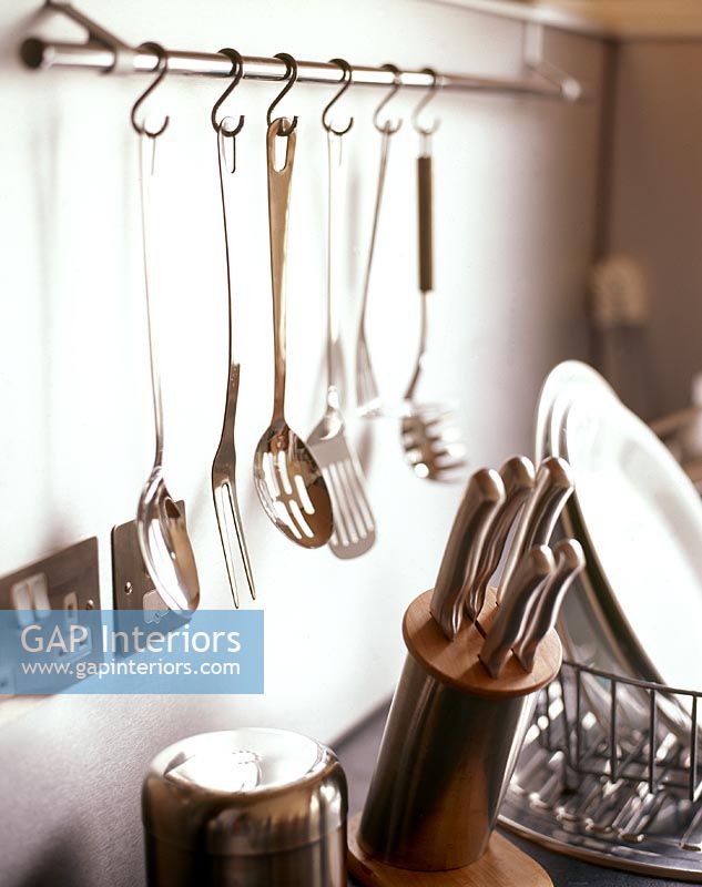 Kitchen utensils hanging from rack