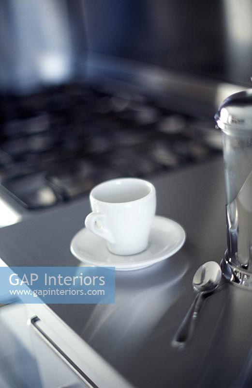 Cup on modern stainless steel kitchen worktop