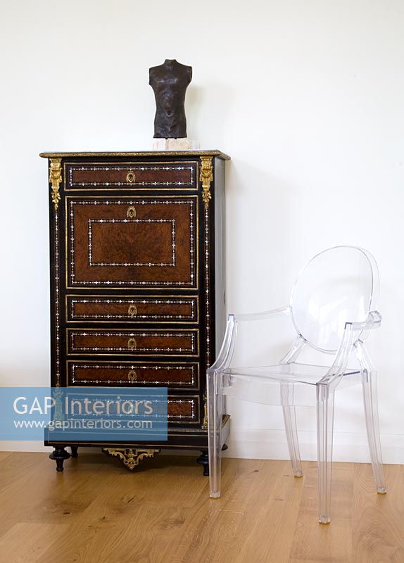 Ornate chest of drawers and ghost chair