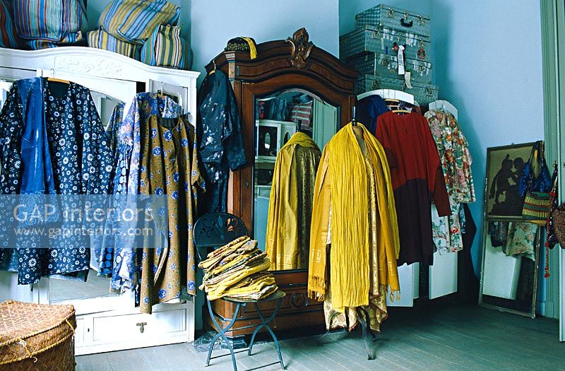 Clothing hanging outside wardrobes 