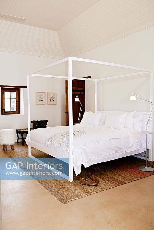 Modern bedroom with four poster bed