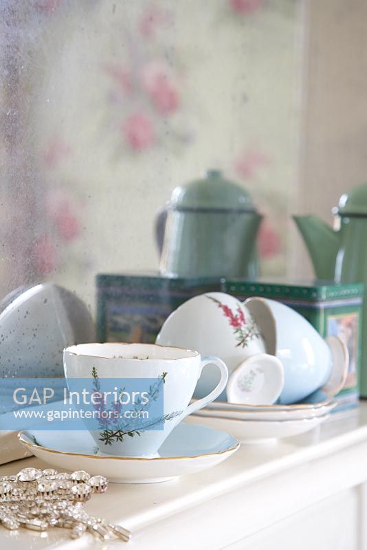Detail of cups and saucers on mantelpiece 