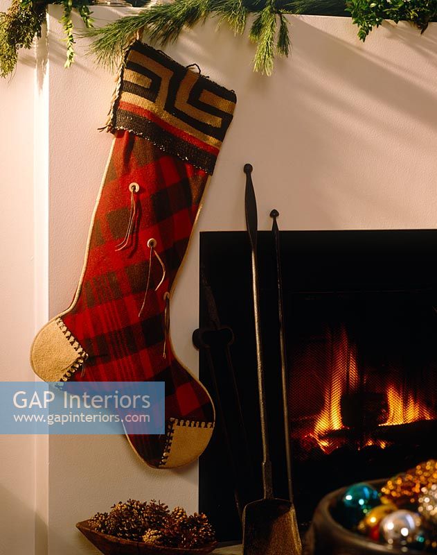 Christmas stocking hung by fireplace 