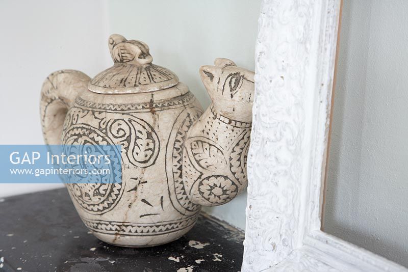 Detail of decorative teapot on shelf 