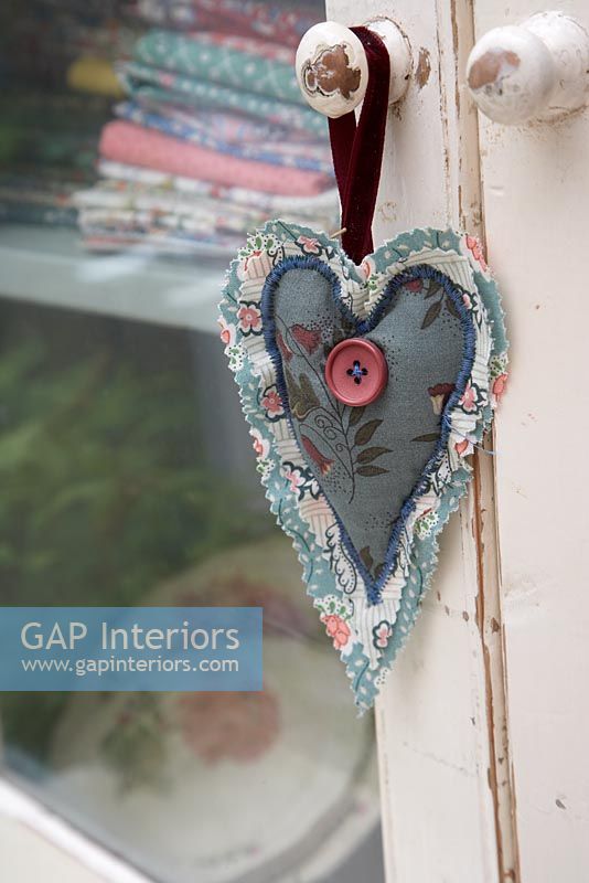 Fabric heart hanging on door handle 