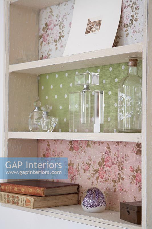 Detail of shelf unit with patterned wallpaper