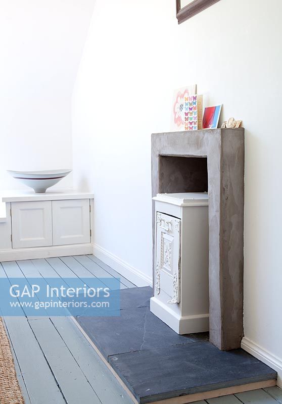 Wooden unit in concrete fireplace 