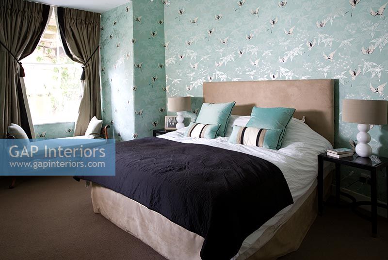 Classic bedroom with patterned wallpaper 