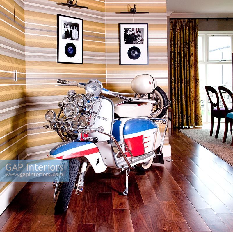 Retro Vespa scooter parked in dining room 