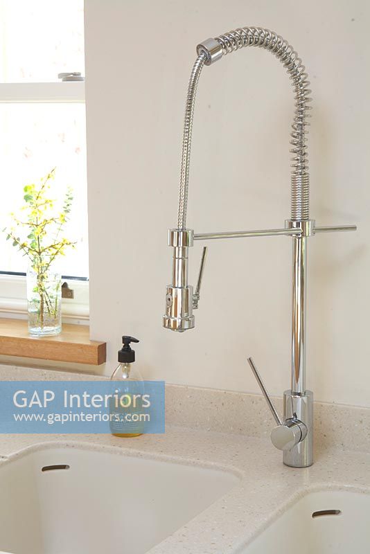 Detail of modern rinse tap in kitchen 