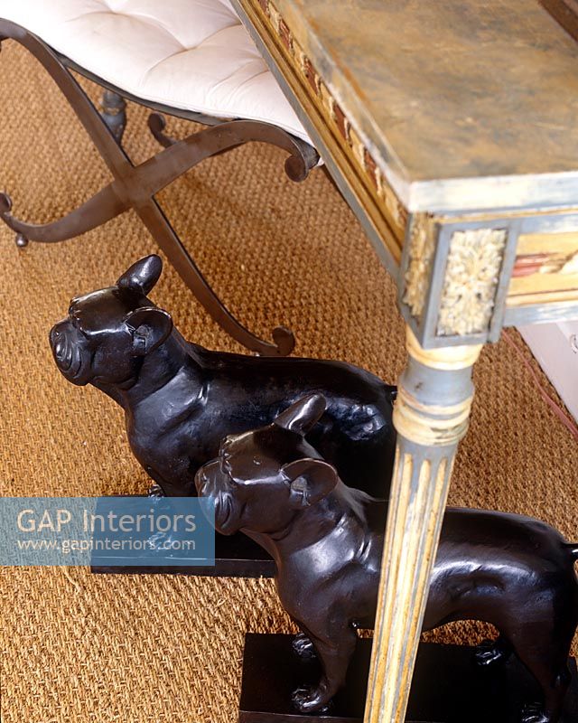Pair of carved dogs under ornate console table