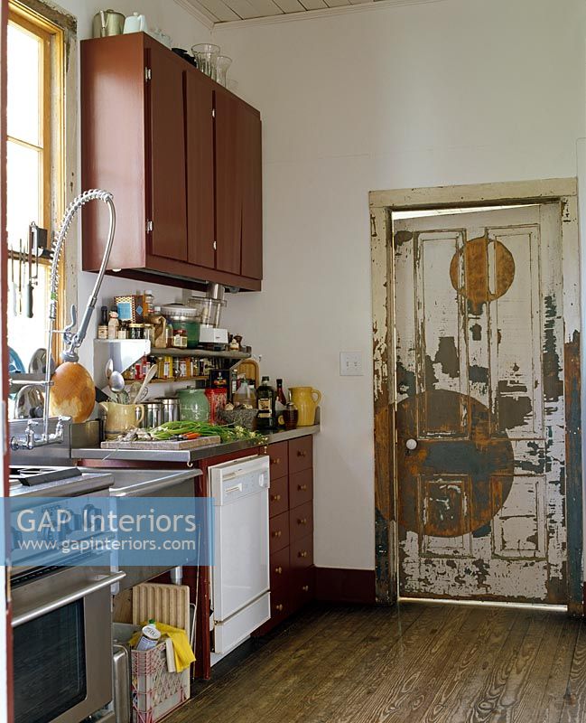 Modern kitchen with distressed wooden door 