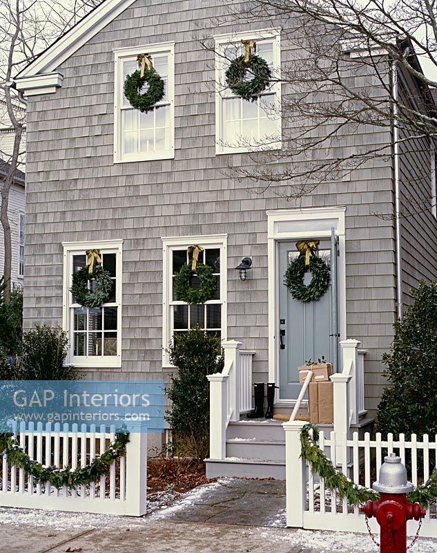 Christmas wreaths on classic house exterior 