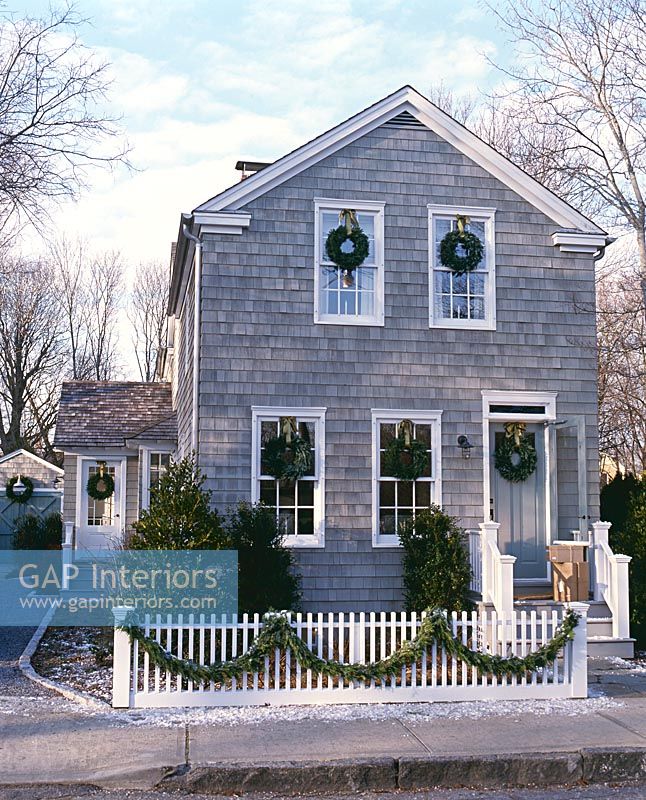 Christmas wreaths on classic house exterior 
