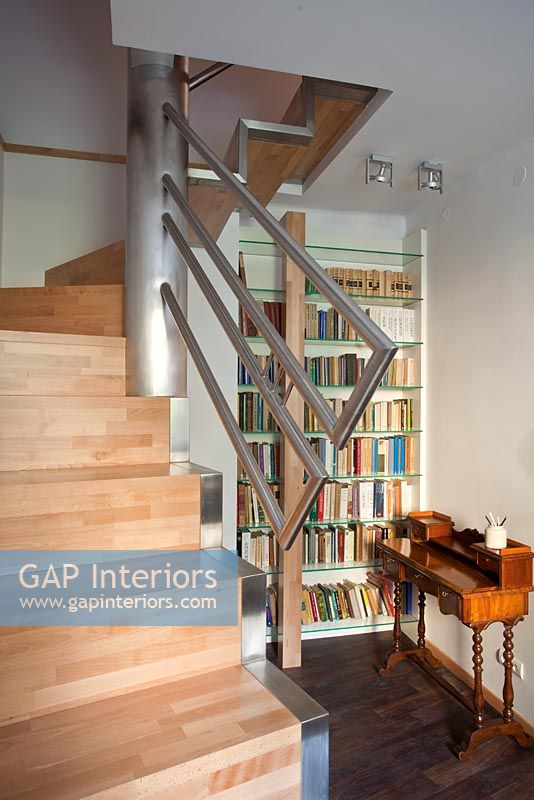 Modern staircase and hallway with bookcase 