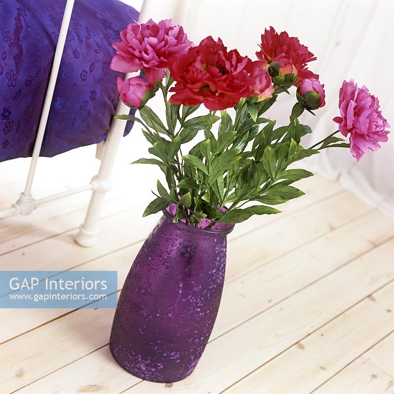 Detail of purple vase of flowers 