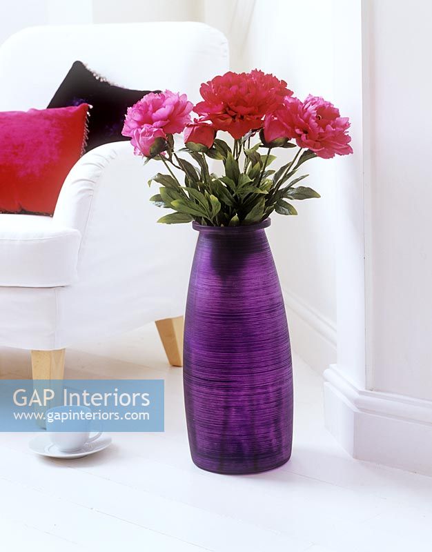 Large purple vase of flowers 