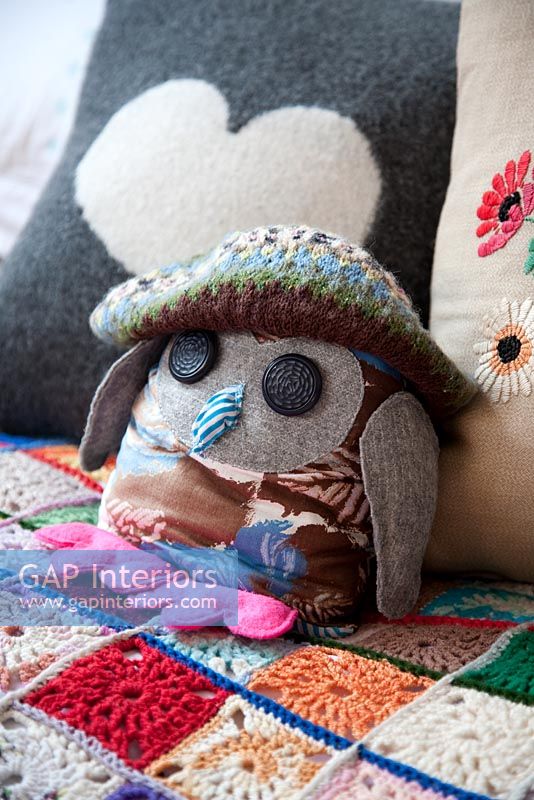 Toy owl on modern bed 