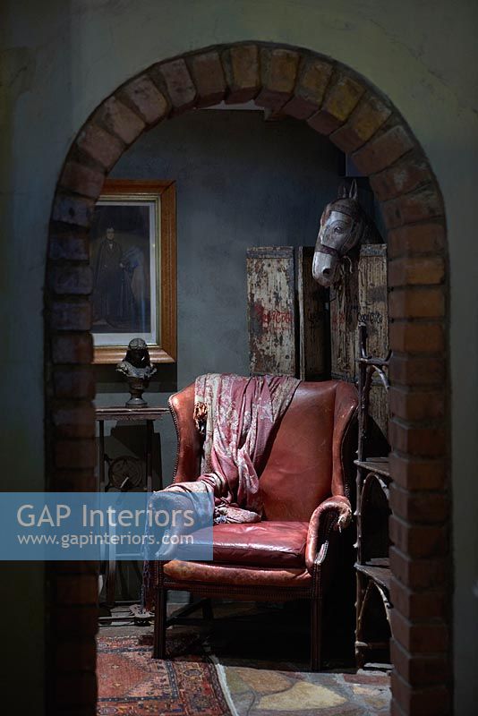 Vintage leather armchair through archway 