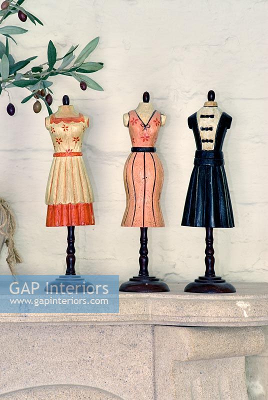 Miniature dressmakers dummies on mantelpiece 
