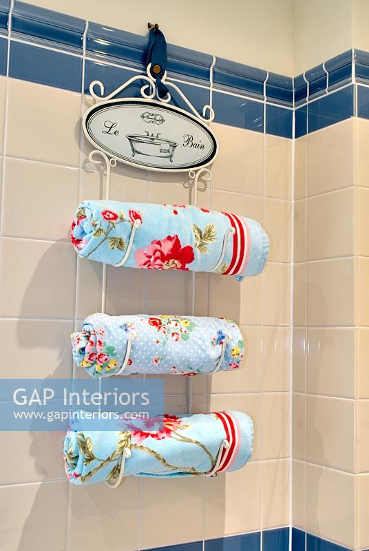 Floral towels on hanging towel rail 