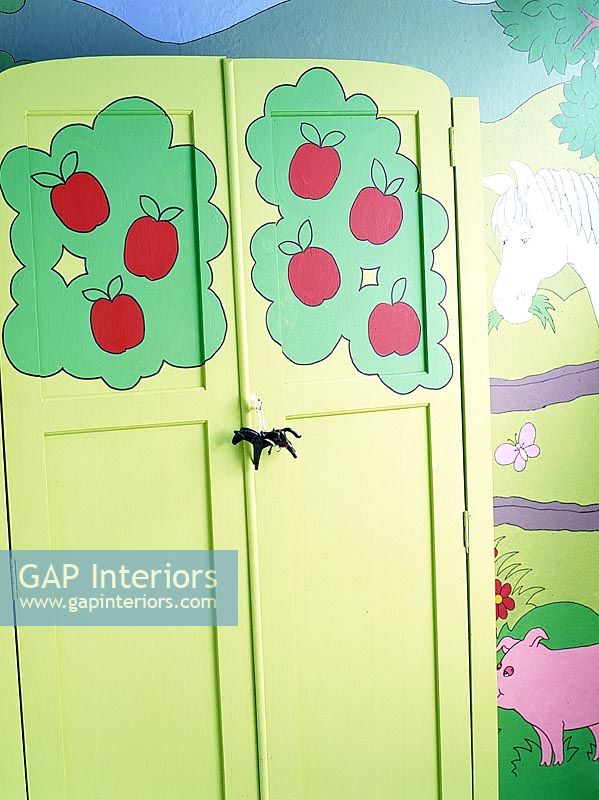 Colourfully painted wardrobe in childrens room