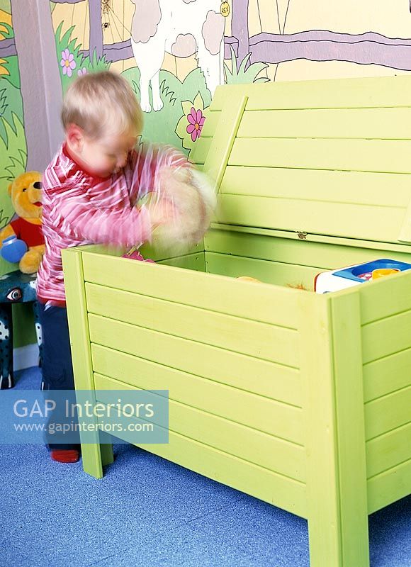 Small child playing in modern toy box 