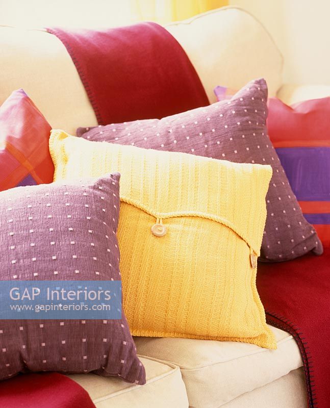 Variety of colourful cushions on sofa 