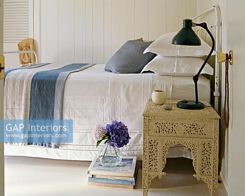Ornate bedside table in country bedroom 