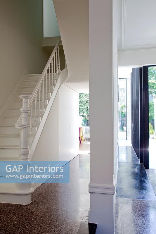 Modern hallway with classic painted staircase