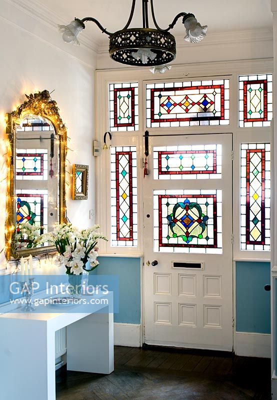 Classic hallway with stained glass front door 